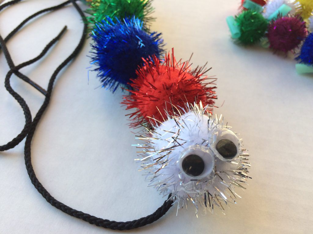 caterpillar bead stringing with pom poms