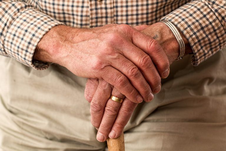 aged hands on a cane