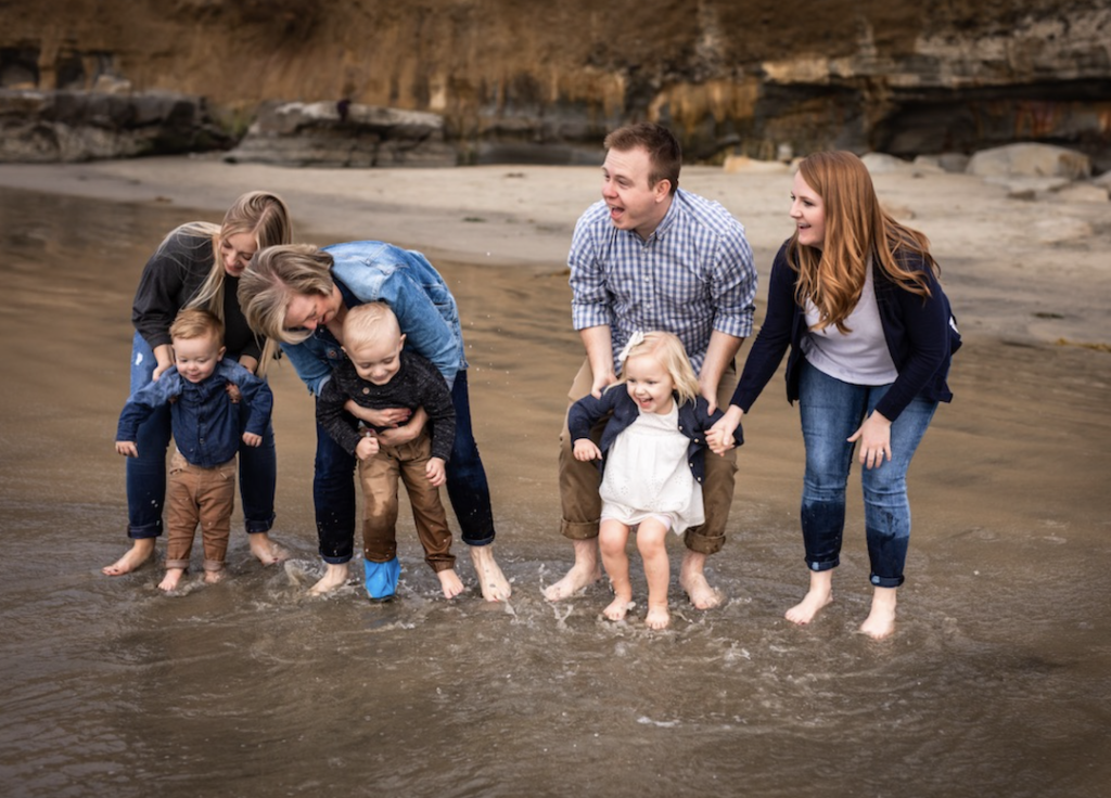 family playing at the beach