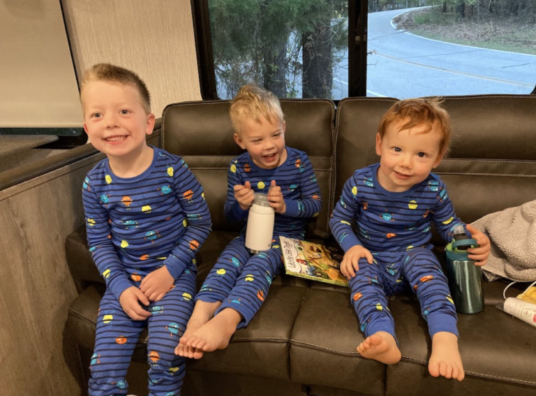 3 boys in matching pajamas in a trailer