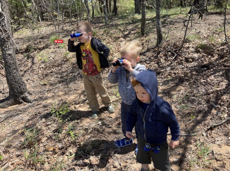 3 boys with small binoculars birdwatching