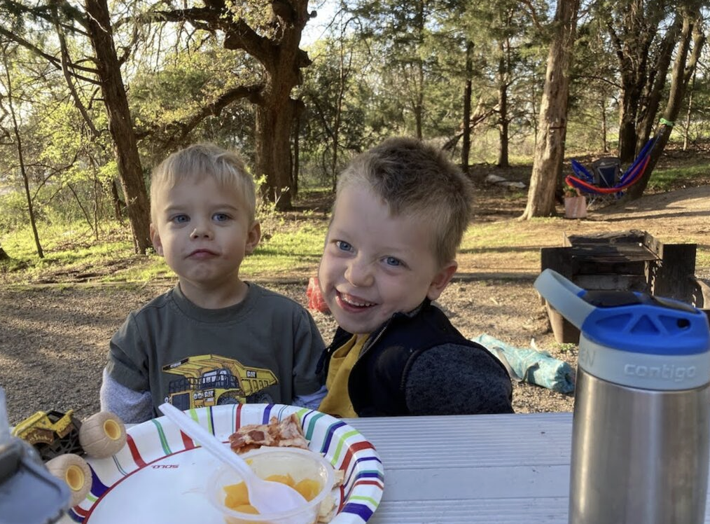 boys eating snacks in a campground