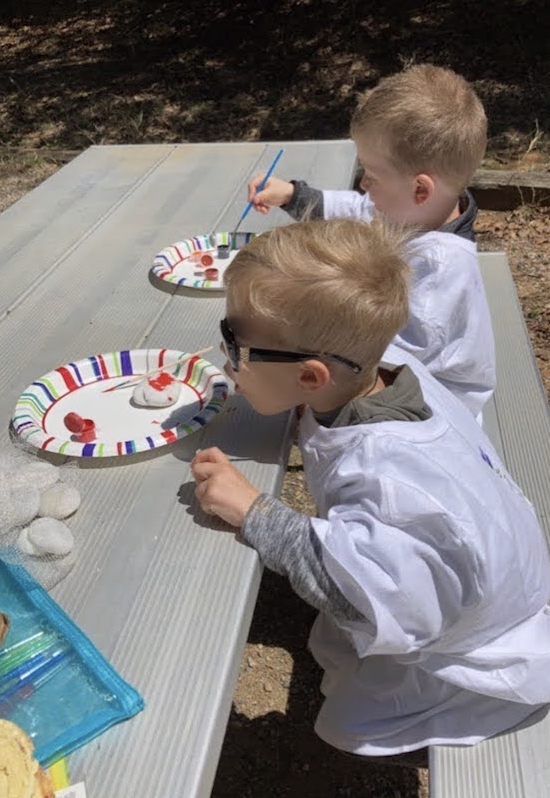 Kids eating snacks at a picnic table