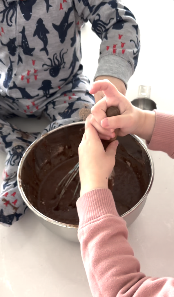 stirring a bowl of brownie mix