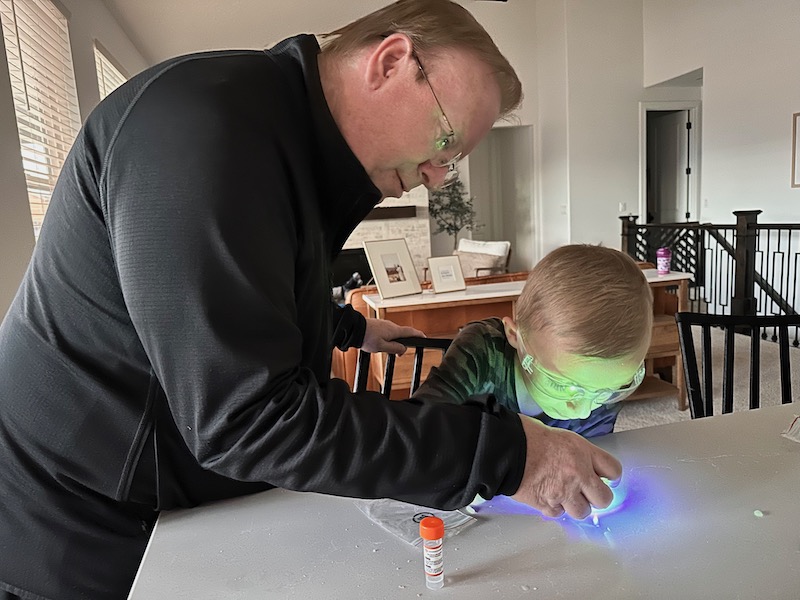 grandfather making slime with grandchild