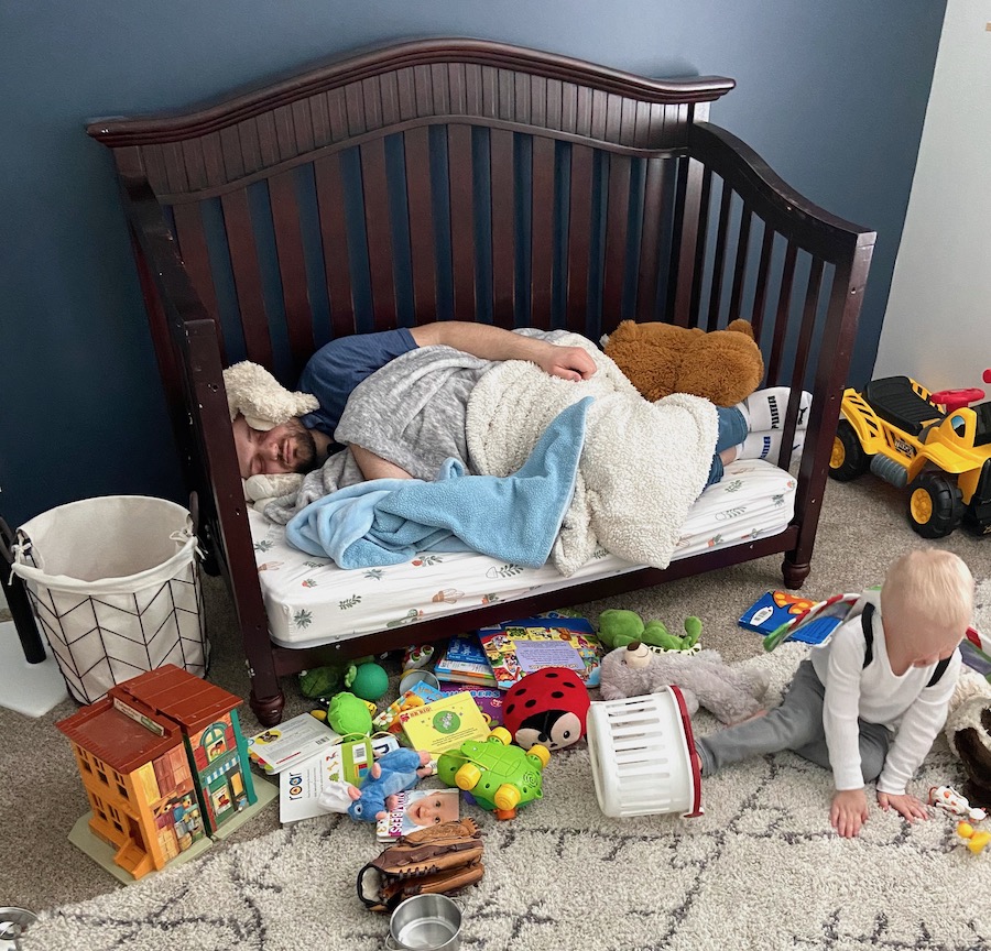 Exhausted father with child at naptime