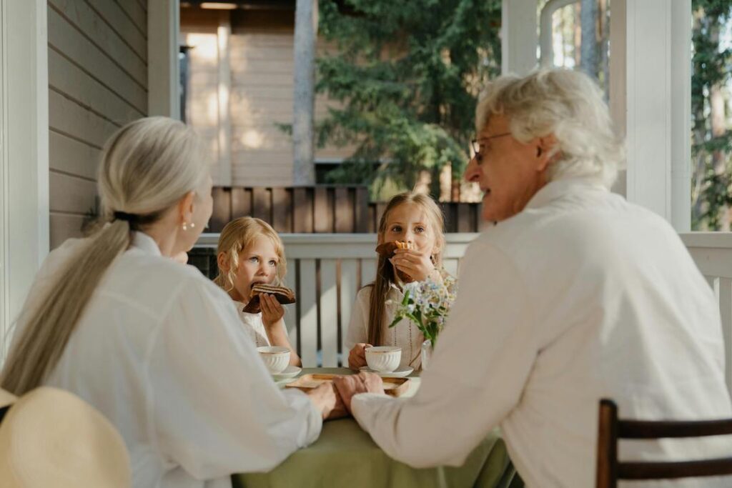 Grandparents eating picnic with grandkids