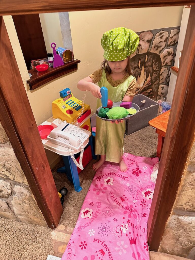 girl playing store in a playhouse