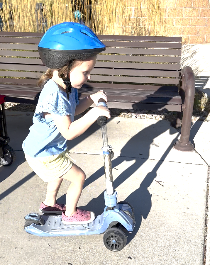 girl riding scooter