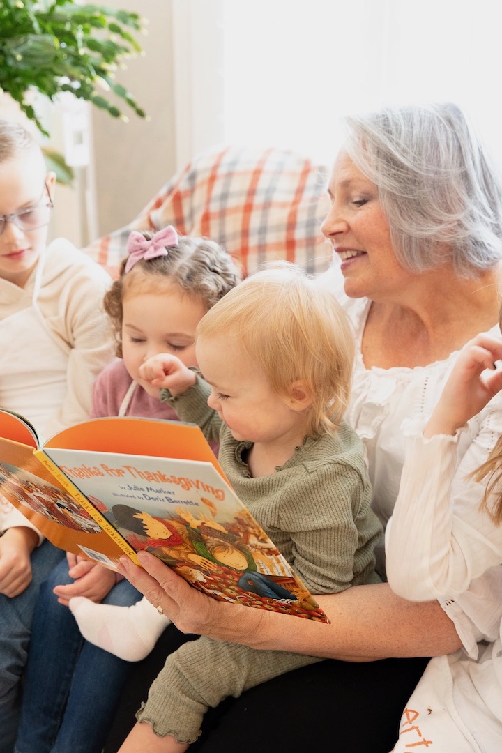 Grandmother reading to grandchildren