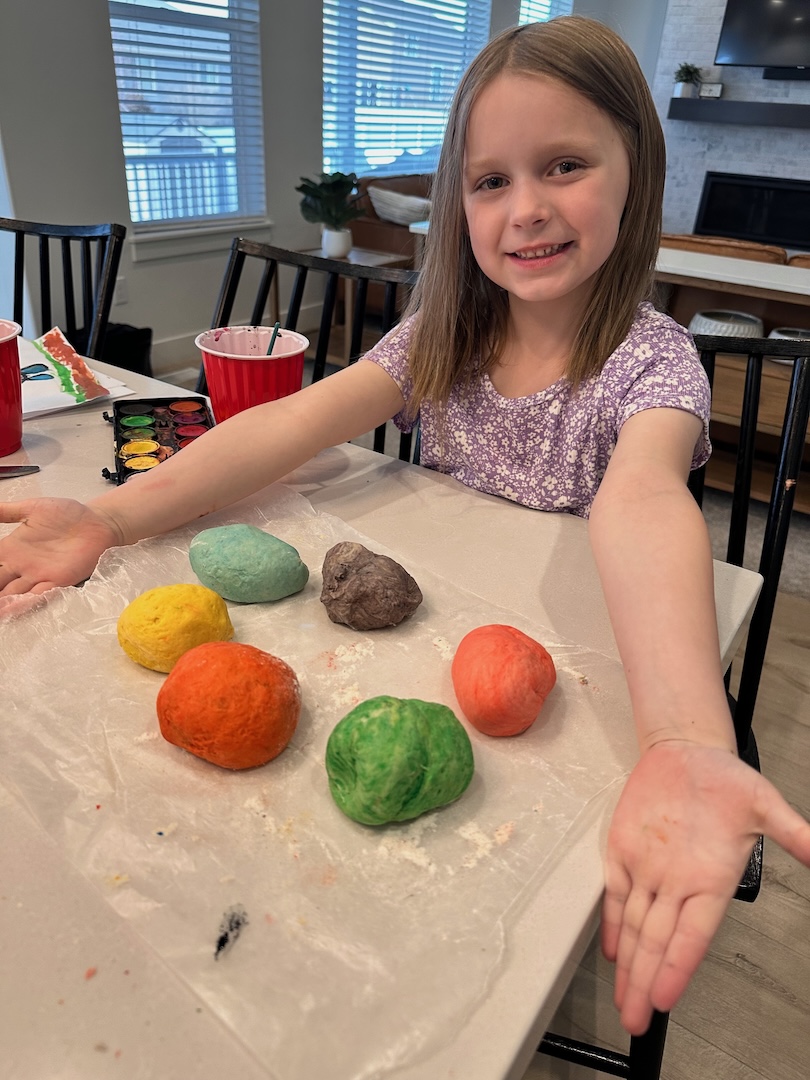 six balls of colorful dough